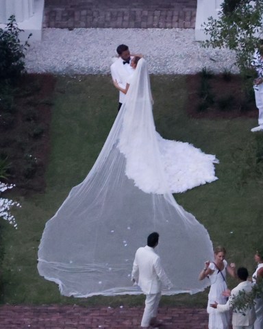 Savannah, GA  - *PREMIUM-EXCLUSIVE*  - And the bride wore… white. Jennifer Lopez wears a stunning white wedding dress as she celebrates her marriage to Ben Affleck, suitably dashing in a white jacket and black pants. The couple kissed and posed for pics around Ben’s $8million Georgia mansion on Saturday evening before spending the night celebrating their love and their union with family and a raft of A-list friends. All the couple’s children from their new blended family were also spotted on a walkway leading to Ben’s plantation style house with two of the boys carrying J Lo, now Jennifer Affleck’s, incredible train.

Pictured: Ben Affleck and Jennifer Lopez

BACKGRID USA 20 AUGUST 2022 

USA: +1 310 798 9111 / usasales@backgrid.com

UK: +44 208 344 2007 / uksales@backgrid.com

*UK Clients - Pictures Containing Children
Please Pixelate Face Prior To Publication*