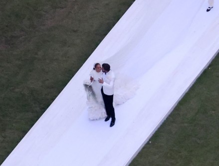 Savannah, GA - *PREMIUM-EXCLUSIVE* - And the bride wore…white.  Jennifer Lopez rocks a stunning white wedding dress as she celebrates her nuptials to Ben Affleck, dashing suitably in a white jacket and black pants.  The couple kissed and posed for photos around Ben's $8 million Georgian mansion on Saturday night before spending the night celebrating their love and union with family and a host of high-profile friends.  All of the couple's children from their new blended family were also spotted on a walkway leading to Ben's plantation-style home with two of the boys carrying J Lo, now Jennifer Affleck's Amazing Train.  Pictured: Ben Affleck and Jennifer Lopez BACKGRID USA 20 AUG 2022 USA: +1 310 798 9111 / usasales@backgrid.com UK: +44 208 344 2007 / uksales@backgrid.com *UK Clients - Images containing children Please pixelate face before Publication*