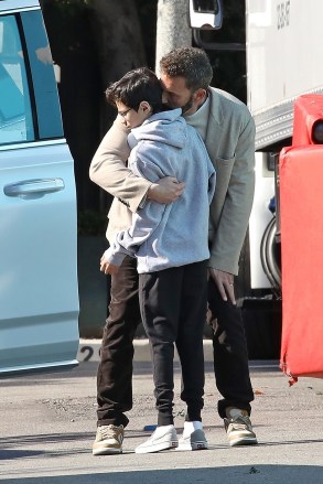 Beverly Hills, CA - *EXCLUSIVE* - Ben Affleck gives Max a sweet hug and kiss as he arrives at a local studio in Los Angeles on Monday morning.  The doting stepdad was seen sharing a sweet moment with Jennifer's 14-year-old son, whom he shares with his ex Marc Anthony.  Ben was seen wearing brown corduroy pants, a cream sweater, sneakers, and a blazer as he stepped out this morning.  The actor will celebrate his first Christmas with the new Jennifer Lopez this weekend.  Pictured: Ben Affleck, Maximilian David Muniz BACKGRID USA DECEMBER 19, 2022 BYLINE MUST READ: Vasquez / BACKGRID USA: +1 310 798 9111 / usasales@backgrid.com UK: +44 208 344 2007 / uksales@backgrid.com *Customers UK - Images Containing Pixelate Children's Face Before Publication*