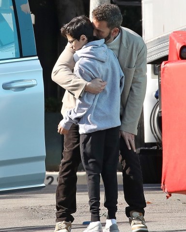 Beverly Hills, CA  - *EXCLUSIVE*  - Ben Affleck gives Max a sweet hug and a kiss as he arrives at a local Studio in L.A Monday morning. The doting stepdad was seen sharing a sweet moment with Jennifer's 14 year old son whom she shares with ex Marc Anthony. Ben was seen in brown corduroy pants, a cream sweater, sneakers and blazer as he headed out this morning. The actor will be celebrating his first Christmas with new wide, Jennifer Lopez this weekend.Pictured: Ben Affleck, Maximilian David MunizBACKGRID USA 19 DECEMBER 2022 BYLINE MUST READ: Vasquez / BACKGRIDUSA: +1 310 798 9111 / usasales@backgrid.comUK: +44 208 344 2007 / uksales@backgrid.com*UK Clients - Pictures Containing ChildrenPlease Pixelate Face Prior To Publication*