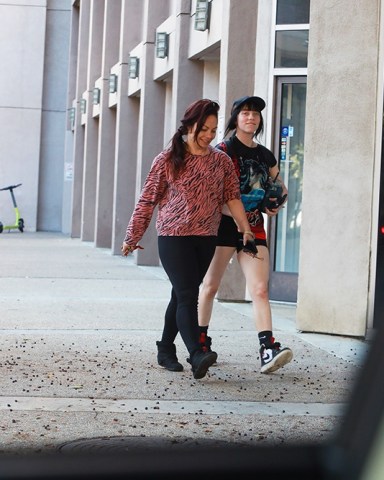 Los Angeles, CA  - *EXCLUSIVE*  - Chart-Topping pop singer Billie Eilish walks alongside a friend after the two finish up a Wednesday workout in Los Angeles. Billie, wearing a black graphic tee and matching workout shorts, was spotted with a smile on her face as she walked back to her ride with a water bottle in hand.Pictured: Billie EilishBACKGRID USA 2 NOVEMBER 2022 USA: +1 310 798 9111 / usasales@backgrid.comUK: +44 208 344 2007 / uksales@backgrid.com*UK Clients - Pictures Containing ChildrenPlease Pixelate Face Prior To Publication*