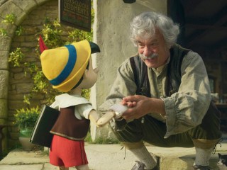 (L-R): Pinocchio (voiced by Benjamin Evan Ainsworth), Tom Hanks as Geppetto, and Figaro in Disney's live-action PINOCCHIO, exclusively on Disney+. Photo courtesy of Disney Enterprises, Inc. © 2022 Disney Enterprises, Inc. All Rights Reserved.