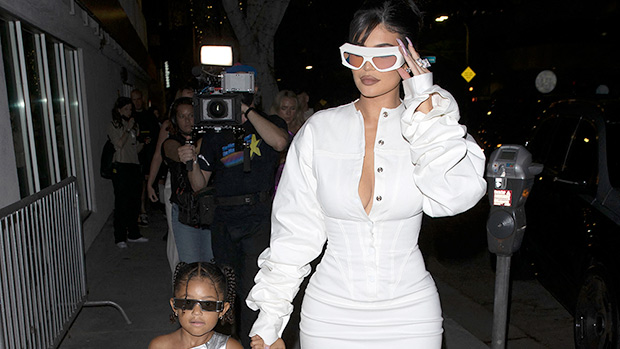 Kylie Jenner Wears Plunging White Dress & Holds Stormi’s Hand At Kylie Cosmetics Party
