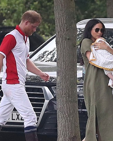 Britain's Prince Harry and Meghan, Meghan Duchess of Sussex walk with their son Archie, at the Royal Charity Polo Day at Billingbear Polo Club, Wokingham, England
Royals, Wokingham, United Kingdom - 10 Jul 2019