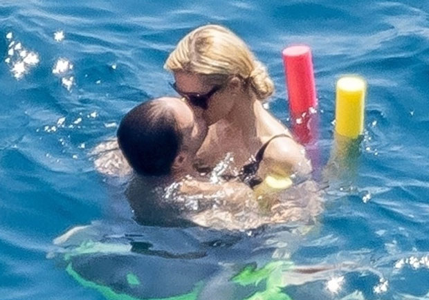 paris hilton looks stylish in a blue louis vuitton sarong while enjoying  her summer holiday with husband carter reum in lake como, italy-040822_16