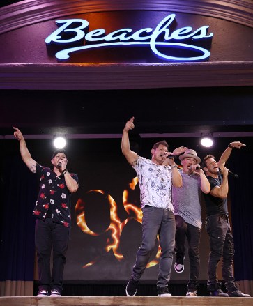 PROVIDENCIALES, TURKS AND CAICOS ISLANDS - AUGUST 31:  Drew Lachey, Nick Lachey, Justin Jeffre and Jeff Timmons are seen performing on stage during the 98 Degrees Ultimate Throwback Concert at Beaches Turks & Caicos Resort Villages & Spa on August 31, 2022 in Providenciales, Turks and Caicos.  (Photo by Alexander Tamargo/Getty Images for Beaches Resorts)