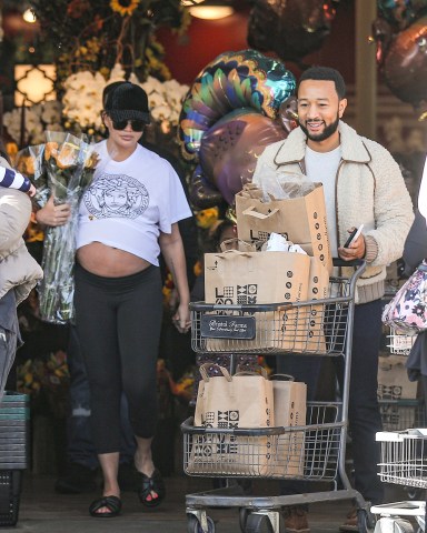 Beverly Hills, CA  - Pregnant Chrissy Teigen and husband John Legend stock up on groceries on Thanksgiving Eve at a Bev Hills grocery store. We catch Chrissy with her pregnant belly on full display as the Versace tee rides up her baby bump. The couple did a handful of shopping leaving the grocery store with two full shopping carts.Pictured: Chrissy Teigen, John LegendBACKGRID USA 23 NOVEMBER 2022 BYLINE MUST READ: SPOT / BACKGRIDUSA: +1 310 798 9111 / usasales@backgrid.comUK: +44 208 344 2007 / uksales@backgrid.com*UK Clients - Pictures Containing ChildrenPlease Pixelate Face Prior To Publication*