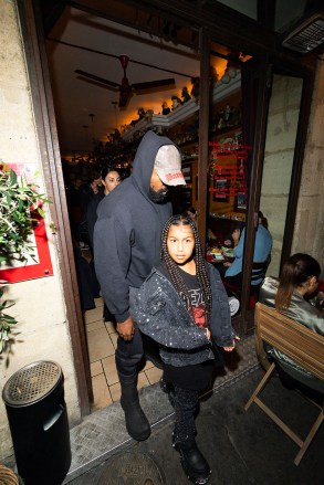 Paris, FRANCE - Kanye West (Ye) went to dinner with his children, North, Saint, and Chicago at Ferdi restaurant during Paris Fashion Week (PFW).  The children then returned with the nanny to the hotel Ritz without their father and one of the children took the opportunity to show his middle fingers through the hotel window.  Pictured: Kanye West, dinner, children, North West, Saint West, Chicago West BACKGRID USA 1 OCTOBER 2022 BYLINE MUST READ: Best Image / BACKGRID USA: +1 310 798 9111 / usasales@backgrid.com UK: +44 208 344 2007 / uksales@backgrid.com *UK Clients - Pictures Containing Children Please Pixelate Face Prior To Publication*