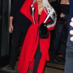 Kim Kardashian slays in a red trench coat as she arrives at Zero Bond