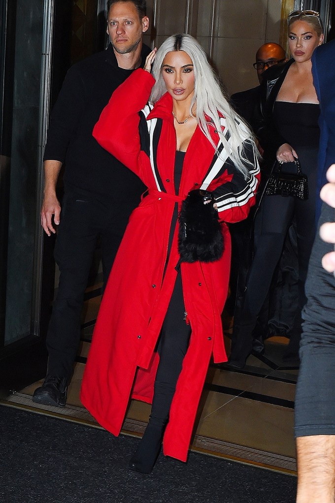 Kim Kardashian slays in a red trench coat as she arrives at Zero Bond