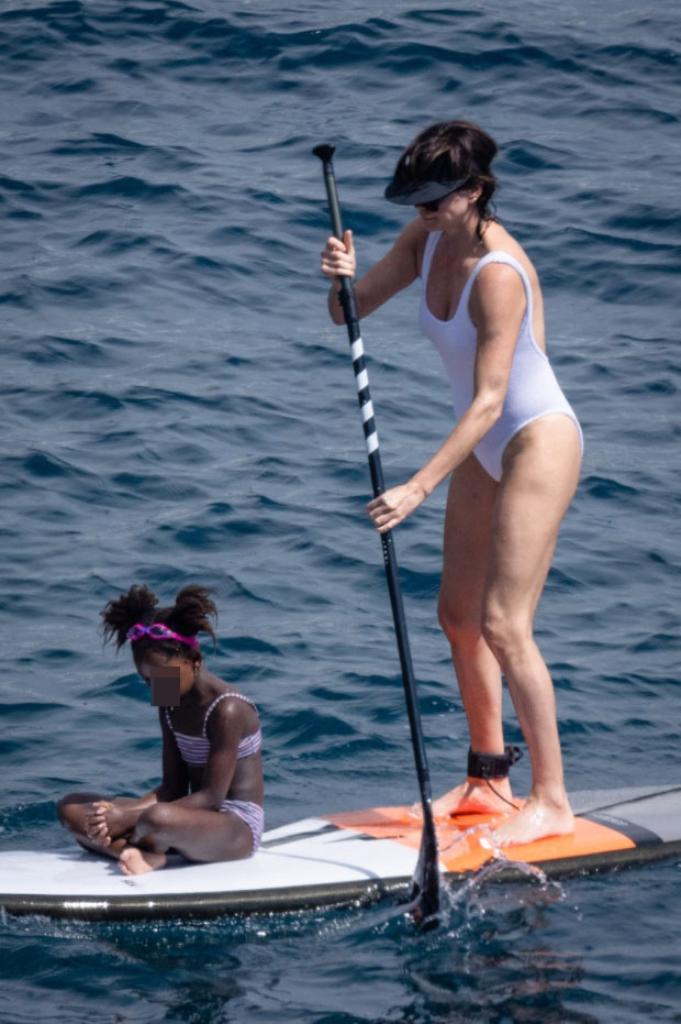 Charlize Theron Rocks White Swimsuit In Italy With Daughters