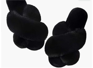 A pair of black fuzzy slippers.