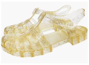 A pair of gold jelly sandals.