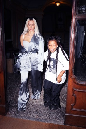 MILAN, ITALY - *EXCLUSIVE* - Kim Kardashian and daughter North West take off from the set of a photo shoot in Milan. Kim rocks a dropped-shouldered look in a satin robe for the occasion. 1 310 798 9111 / usasales@backgrid.com UK: +44 208 344 2007 / uksales@backgrid.com *UK Clients - Photos with children must have their faces pixelated before publishing*