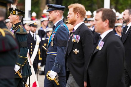 Prince William and Prince Harry follow a gun carriage carrying the coffin of Queen Elizabeth II during her funeral service in Westminster Abbey in central London .The Queen, who died 96 on Sept.  8, will be buried at Windsor alongside her late husband, Prince Philip, who died last year Royals Funeral, London, United Kingdom-19 Sep 2022