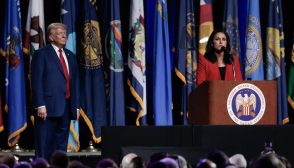 (L-R) Former US President and 2024 Republican presidential candidate Donald Trump looks on as former US Representative Tulsi Gabbard endorses him while she speaks at the National Guard Association conference in Detroit, Michigan, on August 26, 2024. (Photo by JEFF KOWALSKY / AFP) (Photo by JEFF KOWALSKY/AFP via Getty Images)
