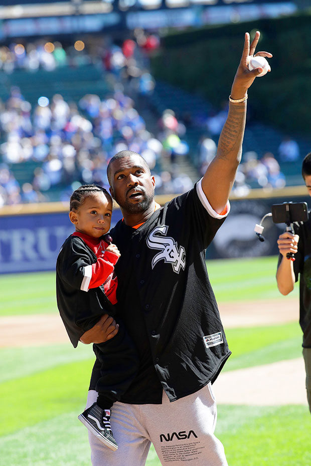 Kanye West sports a hockey jersey and gold chains as he leaves his