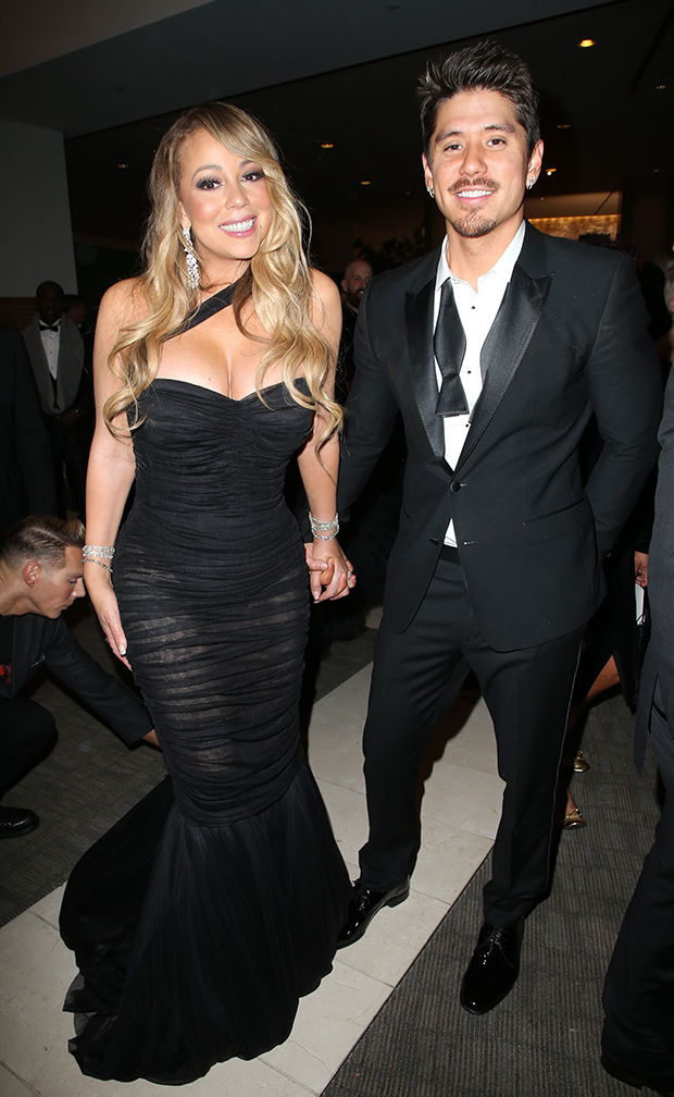 Mariah Carey wears a little black dress and shakes hands with Brian