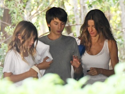 EXCLUSIVE: Gisele Bündchen ditches her wedding band as she takes her two kids to a gym in Miami amid reports she and husband Tom Brady are headed for divorce.  Wearing a white vest top and gray sweats, the 42-year-old Brazilian beauty looked downcast as she took Benjamin, 12, and nine-year-old Vivian for a workout.  The Victoria's Secret model has reportedly been staying with friends in Miami, while star quarterback Brady, 45, is back in Tampa training with his Buccaneers teammates after Hurricane Ian ravaged Florida's west coast.  Both have reportedly hired divorce attorneys and are 
