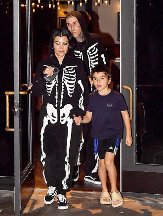EXCLUSIVE: Kourtney Kardashian & Travis Barker Were Spotted Wearing Scary Contact Lenses & Skeleton Onsie After Having Dinner At Their Vegan Restaurant Crossroads In Calabasas, CA The Night Before Halloween. The Two Lovebirds Were In Good Spirits & Were Accompanied By Son Reign. Kourtney Also Shyed Away & Playfully Hid Her Contact Lenses From The Cameras As Travis Watched & Laughed On. 30 Oct 2022 Pictured: Kourtney Kardashian & Travis Barker Were Spotted Wearing Scary Contact Lenses & Skeleton Onsie After Having Dinner At Their Vegan Restaurant Crossroads In Calabasas, CA The Night Before Halloween. The Two Lovebirds Were In Good Spirits & Were Accompanied By Son Reign. Kourtney Also Shyed Away & Playfully Hid Her Contact Lenses From The Cameras As Travis Watched & Laughed On. Photo credit: @CelebCandidly / MEGA TheMegaAgency.com +1 888 505 6342 (Mega Agency TagID: MEGA912919_002.jpg) [Photo via Mega Agency]