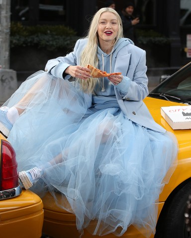 Gigi Hadid stuns in a baby blue tulle skirt while eating a slice of pizza filming a Maybelline commercial in New York CityPictured: Gigi HadidRef: SPL5300390 300322 NON-EXCLUSIVEPicture by: Christopher Peterson / SplashNews.comSplash News and PicturesUSA: +1 310-525-5808London: +44 (0)20 8126 1009Berlin: +49 175 3764 166photodesk@splashnews.comWorld Rights