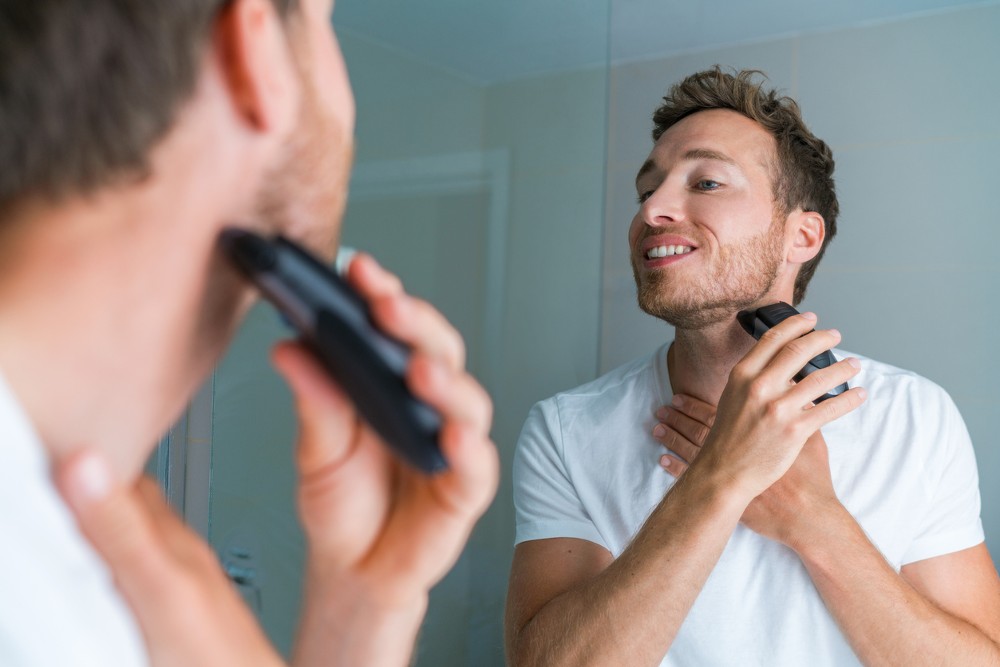 A man shaving with an electric razor