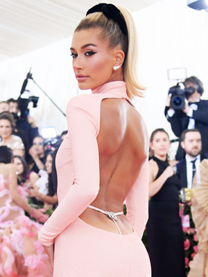 Hailey Bieber gives a hint of midriff in crop top and flared pants during  flurry of selfie photos