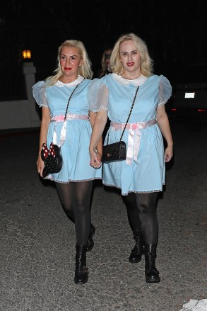 West Hollywood, CA - Comedic actress Rebel Wilson and her girlfriend Ramona Agruma arrive at Vas Morgan and Michael Braun's Halloween party dressed as the twins from 'The Shining.'  Pictured: Rebel Wilson, Ramona Agruma BACKGRID USA 29 OCTOBER 2022 USA: +1 310 798 9111 / usasales@backgrid.com UK: +44 208 344 2007 / uksales@backgrid.com *UK Clients - Pictures Containing Children Please Pixelate Face Prior To Publication*