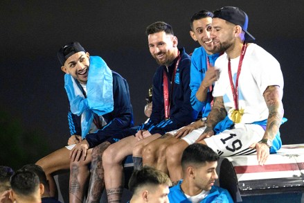 Captain Lionel Messi, send from left, sits with Angel de Maria, second from right, and Nicolas Otamendi, right, atop of a bus driving the players from the Argentine soccer team that won the World Cup after they landed at Ezeiza airport on the outskirts of Buenos Aires, Argentina
Wcup Soccer, Buenos Aires, Argentina - 20 Dec 2022