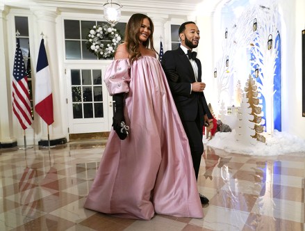Chrissy Teigen, left, and John Legend arrive at the State Dinner with President Joe Biden and French President Emmanuel Macron at the White House in Washington France, Washington, United States - 01 Dec 2022