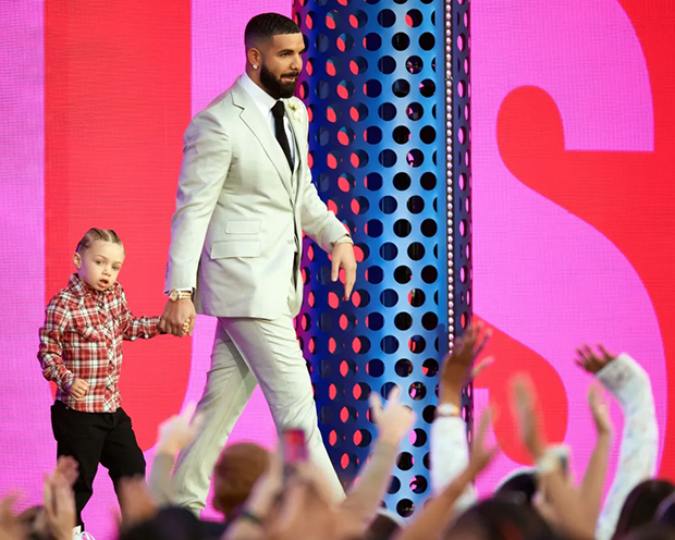 Drake and son Adonis, 5, match in leather jackets at basketball game