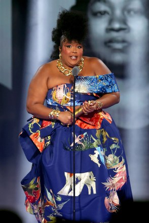 2022 PEOPLE'S CHOICE AWARDS - Photo: Honoree Lizzo accepts The People's Champion award on stage at the 2022 People's Choice Awards held at Barker Hangar, December 6, 2022 -- (Photo by: Rich Polk/E! Entertainment/NBC)