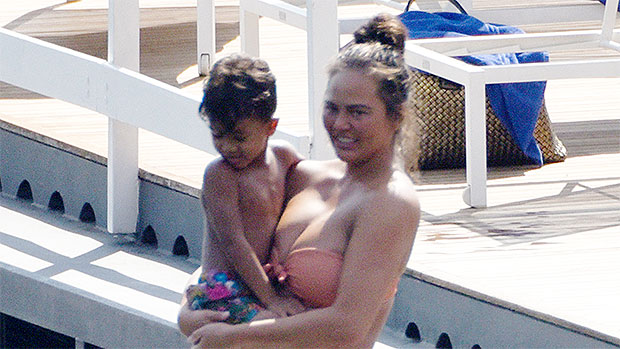 Pregnant Chrissy Teigen shows off her bare bump in a bikini as her son Miles, 4, swims in cute photo