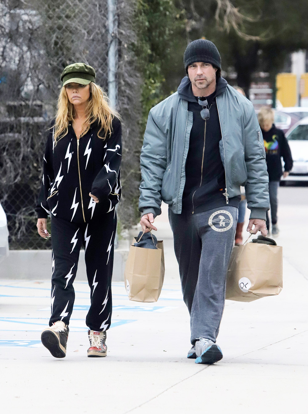 EXCLUSIVE: A sad looking Denise Richards seen out holiday shopping in onesie with husband Aaron Phypers