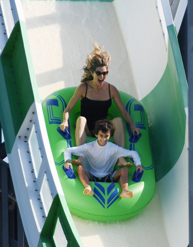 EXCLUSIVE: Newly single Gisele Bundchen wears a black swimsuit as she has fun with her kids and their friend on a waterslide in Miami. 11 Dec 2022 Pictured: Gisele Bundchen. Photo credit: MEGA TheMegaAgency.com +1 888 505 6342 (Mega Agency TagID: MEGA925317_001.jpg) [Photo via Mega Agency]