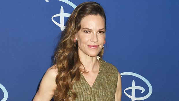 Hilary Swank, 48, shows off her baby bump while decorating a tree