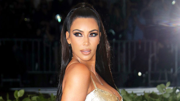 Kim Kardashian Returns To Her Dark Hair & Stuns In A Sparkling Silver Gown For Christmas Eve Bash
