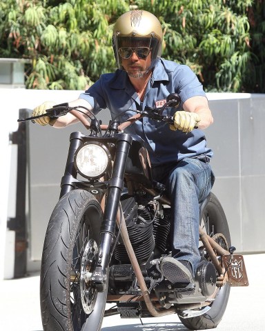 Brad Pitt
Brad Pitt Out and About on a Motorcycle in Los Angeles, America - 15 Jul 2009
Brad Pitt goes "Mechanic Style" one more time for a bike ride. Brad Pitt - aka Mr Jolie - cruising Hollywood's Sunset Boulevard on his custom, 'stripped-down' Harley Davidson, is a fairly common sight in Los Angeles. And he hardly tries to blend into the scenery unnoticed by wearing a bright gold crash helmet and tan leather gloves