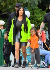 EXCLUSIVE: Kim & Kourtney Kardashian were spotted enjoying a day at Disneyland with their kids in Anaheim, CA. The famous sisters brought all of their kids including North West, Saint West, Penelope Disick, Mason Disick, and Reign Disick. Kim K was seen wearing a bright neon yellow jacket along with bike shorts from her husband’s Yeezus clothing brand. The family was seen enjoying such as Thunder Mountain Railroad, Small World, Dumbo, and the carousel. 22 May 2018 Pictured: Kim Kardashian, Saint West, North West, Kourtney Kardashian, Mason Disick, Reign Disick, Penelope Disick. Photo credit: Snorlax / MEGA TheMegaAgency.com +1 888 505 6342 (Mega Agency TagID: MEGA226927_003.jpg) [Photo via Mega Agency]