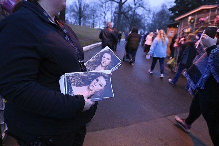 An attendant holds programs as fans enter Graceland for a memorial service for Lisa Marie Presley, in Memphis, Tenn. She died Jan. 12 after being hospitalized for a medical emergency and was buried on the property next to her son Benjamin Keough, and near her father Elvis Presley and his two parents
Lisa Marie Presley Memorial, Memphis, United States - 22 Jan 2023