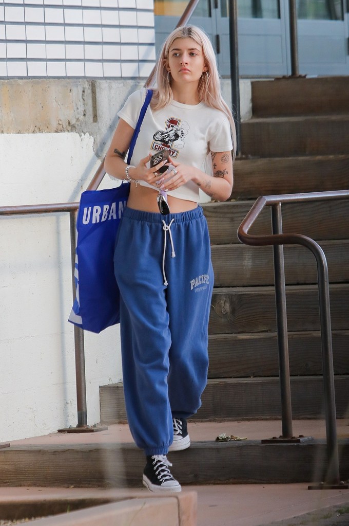 Hailey Bieber reveals her taut midriff while modeling a lavender