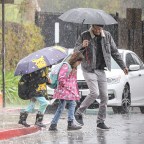 *EXCLUSIVE* Ashton Kutcher does his best to stay dry during a rainy day school run in LA
