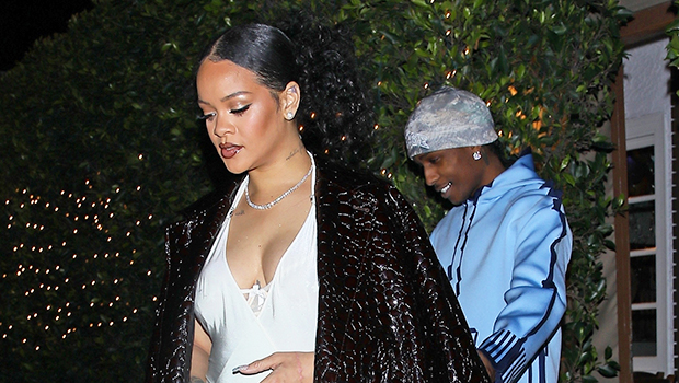 Rihanna embarazada acuna el bulto del bebé mientras usa un mini vestido blanco sedoso para su fiesta de cumpleaños