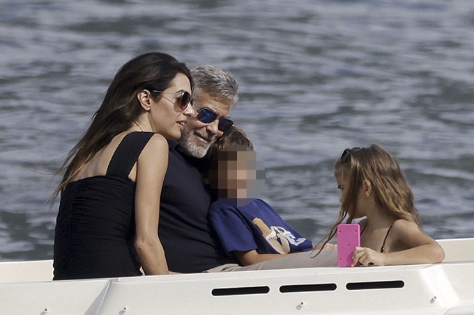 George Clooney & Amal Clooney on a boat with their kids