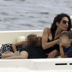George Clooney and Amal Clooney, accompanied by their sleepy kids Ella and Alexander, embark on a picturesque boat trip in Como