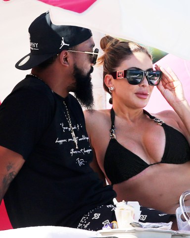 EXCLUSIVE: Bikini-clad Larsa Pippen and Marcus Jordan go public with their relationship for the first time while strolling with arms entwined on the beach in Miami. The 48-year-old Real Housewives of Miami star showed off her curves in a black bikini while walking from the ocean with Jordan, the 31-year-old son of basketball legend Michael. Larsa, married for 23 years to Michael Jordan’s Chicago Bulls teammate Scotty Pippen, has previously said her and Marcus were simply ‘friends’. But on Sunday the loved-up couple were seen making out under a beach umbrella. They walked in front of other bathers with their arms around each other while soaking up the sun on South Beach. At one point, Marcus could be seen gently nuzzling Larsa’s shoulder. “I have a lot of friends," she was reported as saying a month ago. “I mean, I'm very social. I was married for 23 years. This is the time for me to really, like, hone in on my relationships, so that’s kind of what I’m doing." But it seems their relationship has moved on a notch since then. Larsa and ex-Scottie were married from 1997 to 2021 — finalizing their divorce in December, though they split three years earlier. They share four children — Scotty Jr., 21, Preston, 20, and Justin, 17, and daughter Sophia, 14 — and remain close. 13 Nov 2022 Pictured: Larsa Pippen; Marcus Jordan. Photo credit: MEGA TheMegaAgency.com +1 888 505 6342 (Mega Agency TagID: MEGA917633_043.jpg) [Photo via Mega Agency]