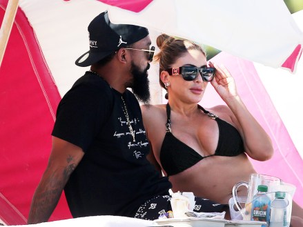 EXCLUSIVE: Bikini-clad Larsa Pippen and Marcus Jordan go public with their relationship for the first time while strolling with arms entwined on the beach in Miami. The 48-year-old Real Housewives of Miami star showed off her curves in a black bikini while walking from the ocean with Jordan, the 31-year-old son of basketball legend Michael. Larsa, married for 23 years to Michael Jordan’s Chicago Bulls teammate Scotty Pippen, has previously said her and Marcus were simply ‘friends’. But on Sunday the loved-up couple were seen making out under a beach umbrella. They walked in front of other bathers with their arms around each other while soaking up the sun on South Beach. At one point, Marcus could be seen gently nuzzling Larsa’s shoulder. “I have a lot of friends,