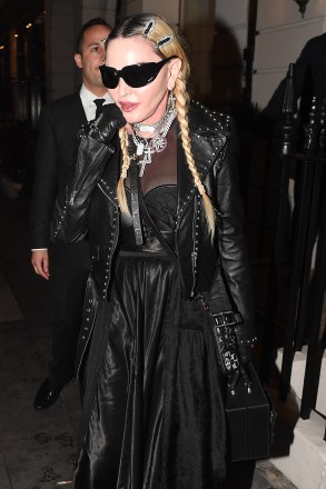 Madonna seen leaving Oswald's Private Members club in soho after partying with FKA Twigs. Madonna was seen flashing her endless bling as she stepped out dripped in Jewellery. Madonna was seen flashing a diamond M ring as she left the members club in dark shades. Pictured: Madonna Ref: SPL5313761 250522 NON-EXCLUSIVE Picture by: SplashNews.com Splash News and Pictures USA: +1 310-525-5808 London: +44 (0)20 8126 1009 Berlin: +49 175 3764 166 photodesk@splashnews.com World Rights