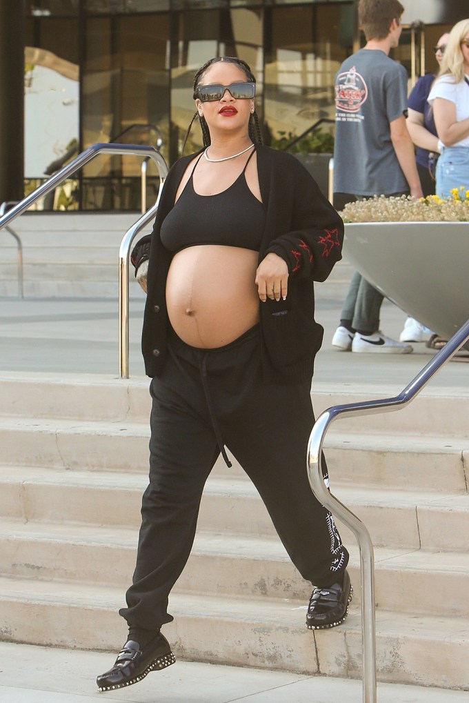 Rihanna shows sweet baby bump in leather jacket for Louis Vuitton