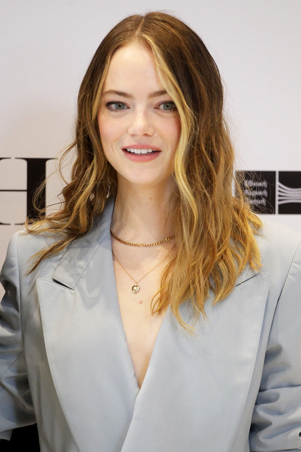 Emma Stone poses at the photocall for Louis Vuitton Cruise